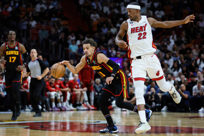 Atlanta Hawks guard Trae Young dribbles past Miami Heat forward Jimmy Butler.